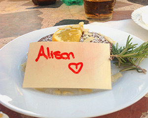 Plate of food with a note saying love Alison